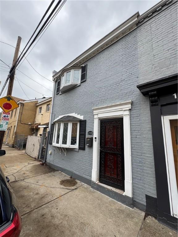 exterior space with brick siding