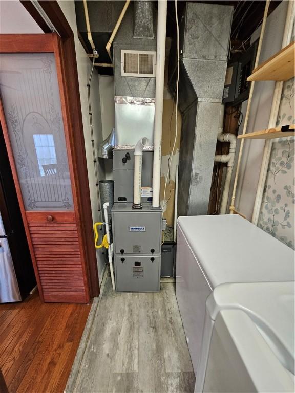 utility room featuring separate washer and dryer and visible vents