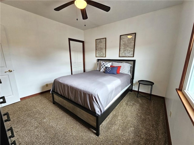 carpeted bedroom featuring baseboards and a ceiling fan