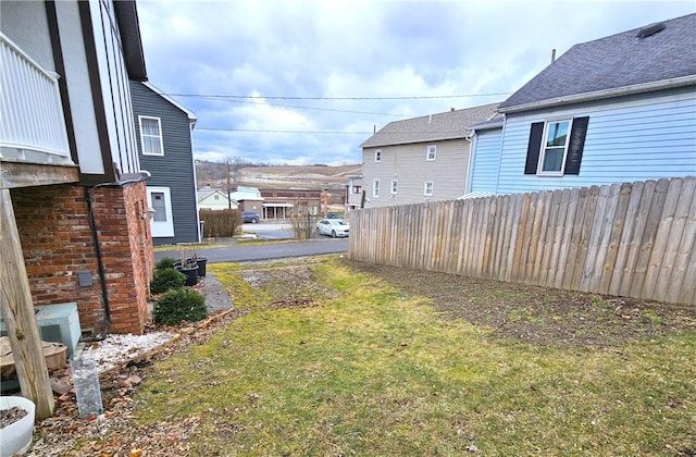 view of yard with fence and a residential view