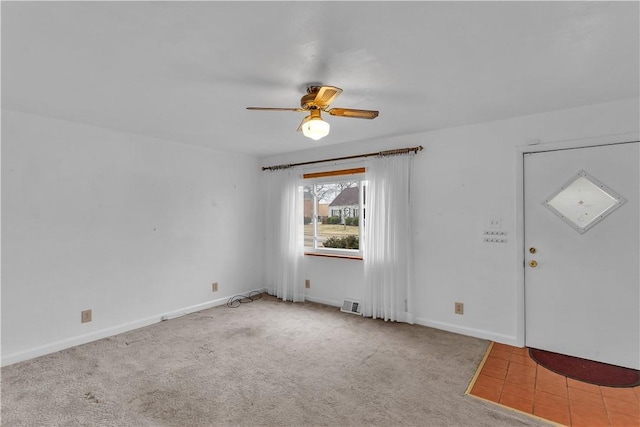 entryway featuring carpet floors, baseboards, visible vents, and a ceiling fan