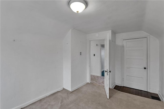 additional living space with lofted ceiling and baseboards