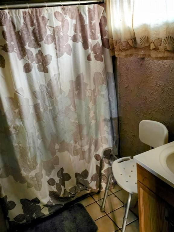 full bath featuring tile patterned flooring, vanity, and a shower with curtain