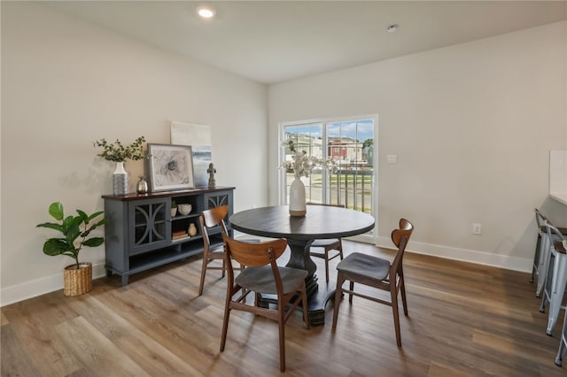 dining room with recessed lighting, baseboards, and wood finished floors