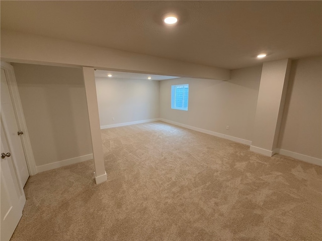 basement featuring recessed lighting, light carpet, and baseboards