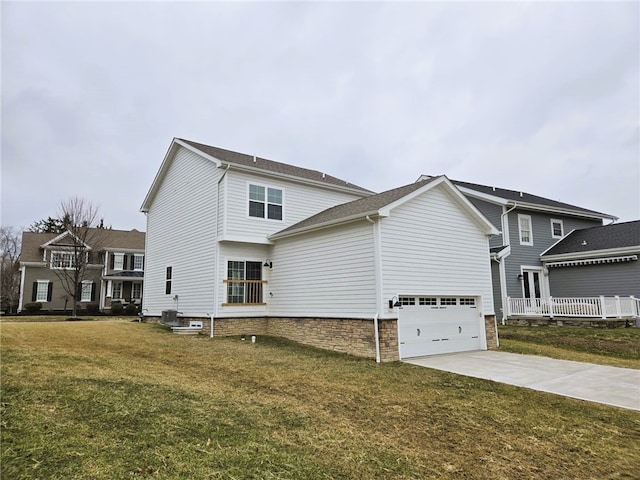 exterior space featuring a garage, driveway, and a lawn