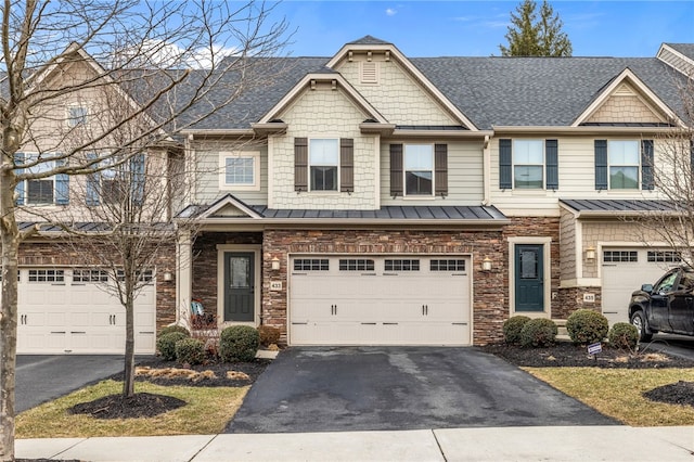 view of property with stone siding, aphalt driveway, roof with shingles, and an attached garage