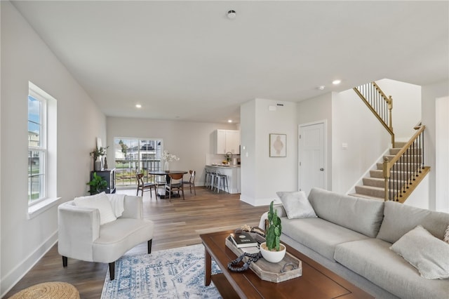 living room with stairs, baseboards, wood finished floors, and recessed lighting