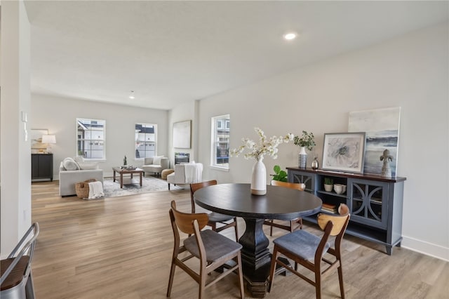 dining area with light wood-style floors, recessed lighting, and baseboards