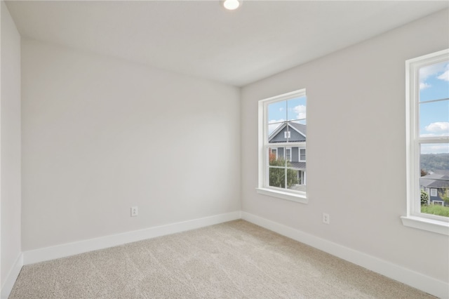 empty room with carpet and baseboards