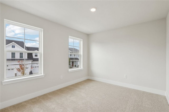 empty room featuring recessed lighting, carpet flooring, and baseboards