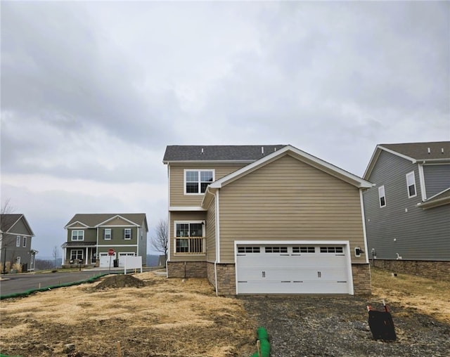 view of front of house featuring stone siding and an attached garage