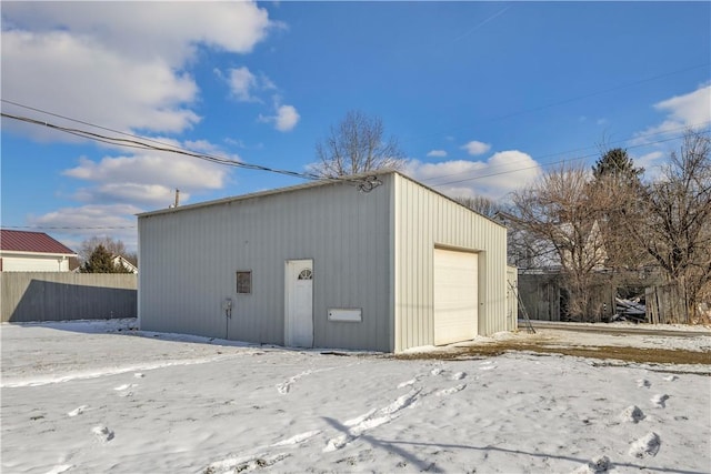 detached garage featuring fence