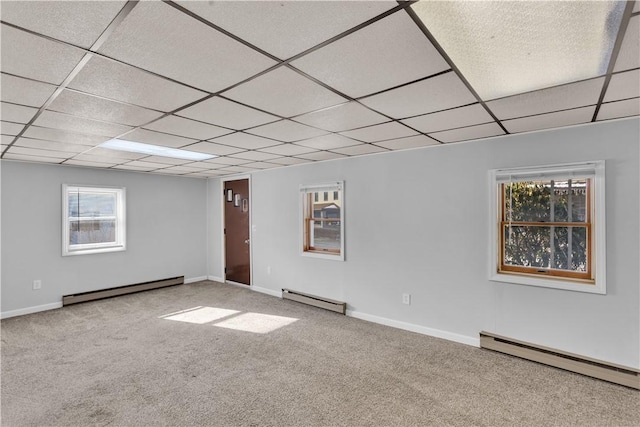 empty room with a baseboard heating unit, a baseboard radiator, and carpet flooring