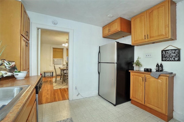 kitchen with stainless steel appliances, light floors, cooling unit, and a sink