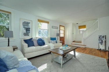 living area featuring stairway and wood finished floors