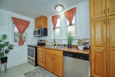 kitchen with stainless steel appliances, a sink, and light countertops