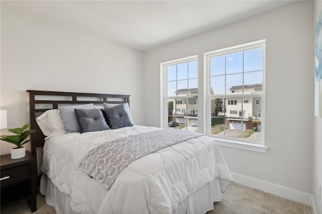 bedroom featuring carpet and baseboards