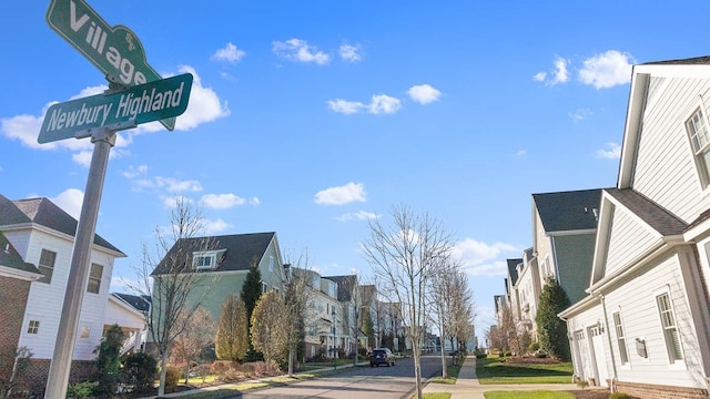 view of road with a residential view, curbs, and sidewalks