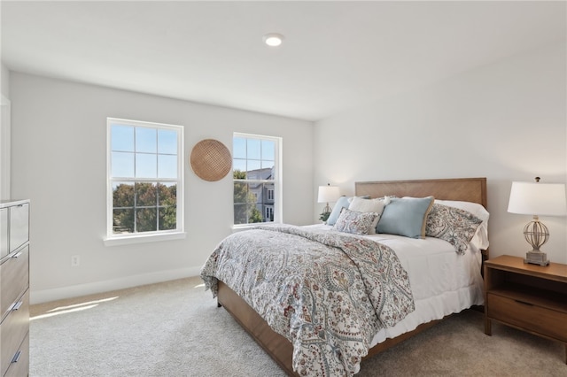 bedroom featuring carpet floors and baseboards