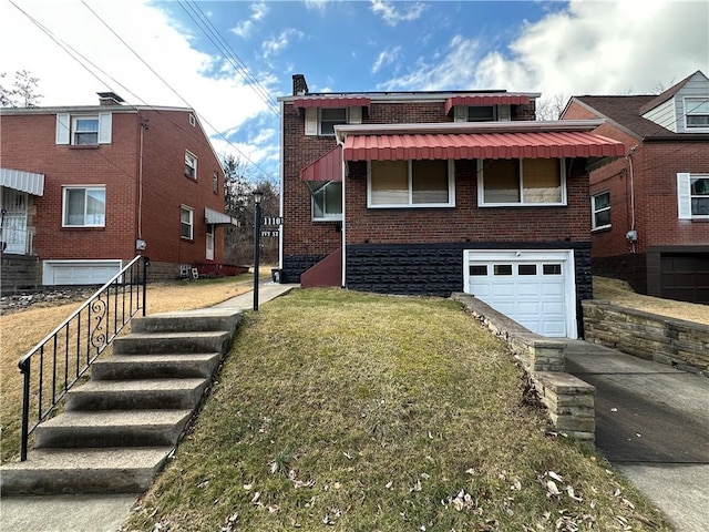 view of front of house featuring an attached garage, driveway, a front yard, and brick siding