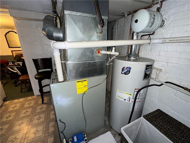 utility room featuring gas water heater and heating unit