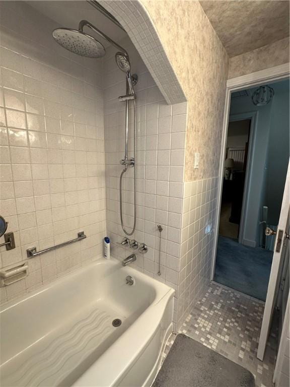 bathroom with tub / shower combination and tile walls