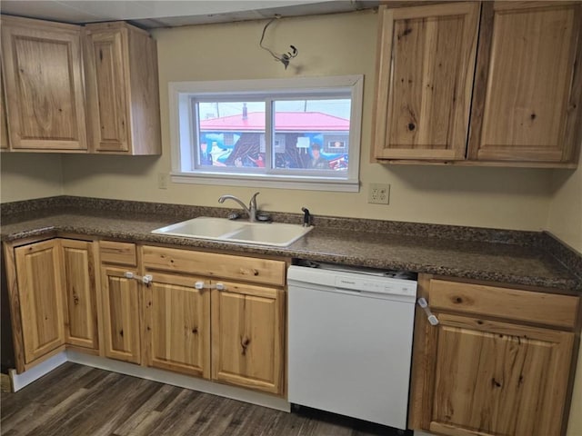 kitchen featuring dark countertops, white dishwasher, dark wood-style flooring, and a sink