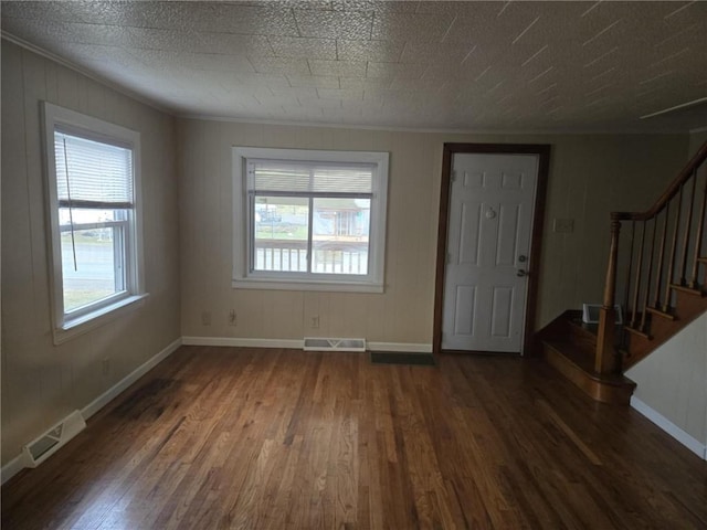 entryway featuring stairs, dark wood-type flooring, and visible vents