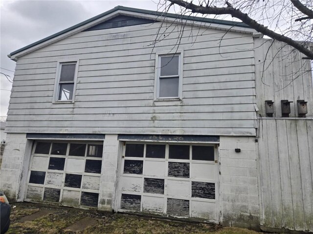 view of side of home with a garage