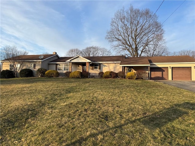 ranch-style house featuring aphalt driveway, a garage, and a front lawn