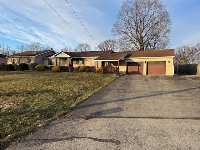 ranch-style house with a porch, an attached garage, a front yard, fence, and driveway