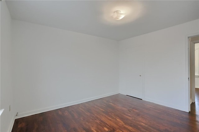 empty room featuring baseboards and wood finished floors