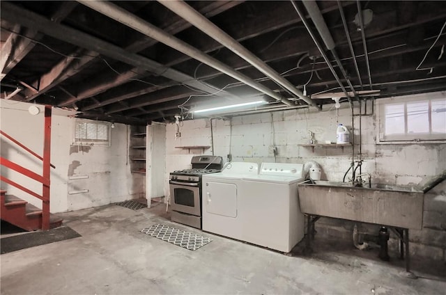 basement with a sink and washing machine and dryer