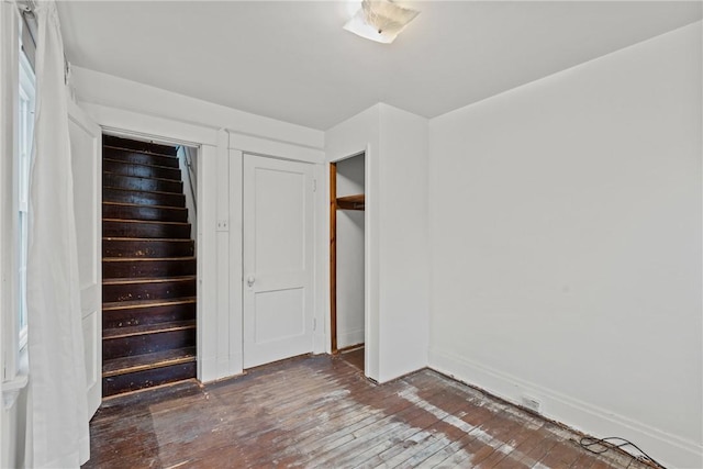 unfurnished bedroom with a closet and hardwood / wood-style flooring