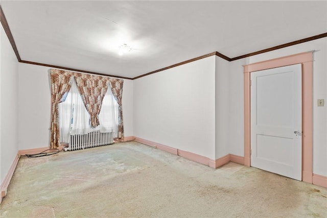 unfurnished room featuring radiator heating unit, baseboards, crown molding, and carpet flooring