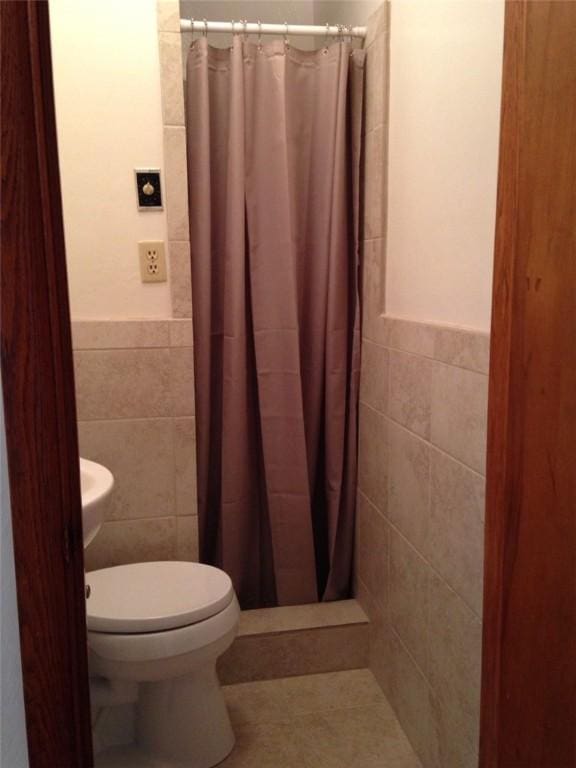 3503 State Route 208, Wilmington Twp, PA 16142 - bathroom with tile walls, a shower stall, a wainscoted wall, and tile patterned flooring