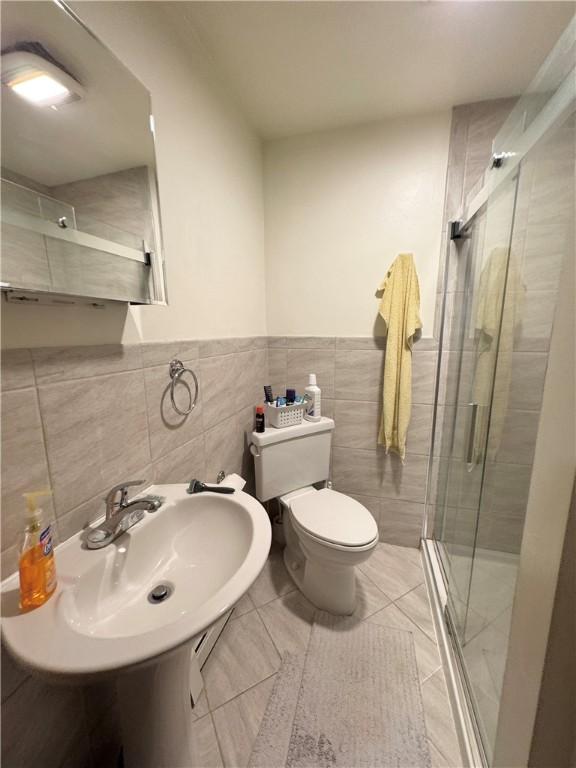 3503 State Route 208, Wilmington Twp, PA 16142 - full bathroom featuring a stall shower, tile walls, tile patterned floors, and wainscoting