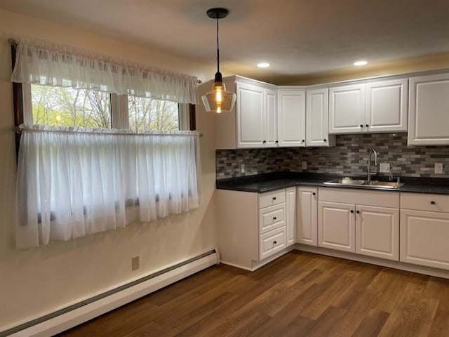3503 State Route 208, Wilmington Twp, PA 16142 - kitchen featuring a baseboard heating unit, dark countertops, white cabinets, tasteful backsplash, and recessed lighting