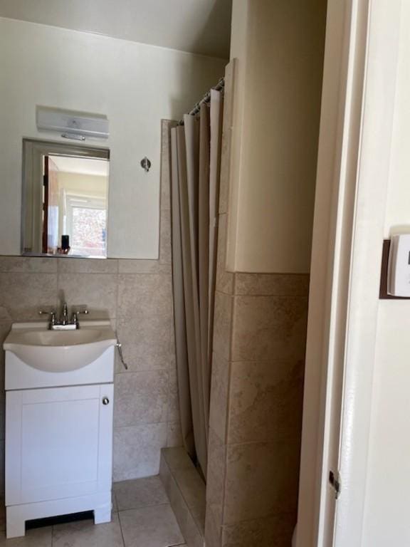 3503 State Route 208, Wilmington Twp, PA 16142 - full bath featuring tile walls, vanity, a shower with curtain, tile patterned floors, and a wainscoted wall