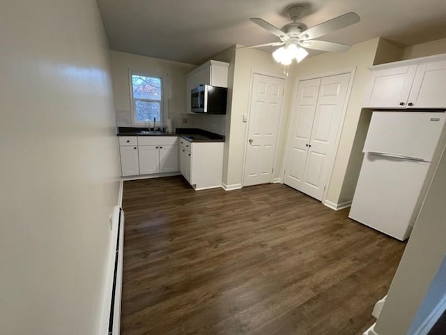 3503 State Route 208, Wilmington Twp, PA 16142 - kitchen featuring stainless steel microwave, freestanding refrigerator, dark countertops, white cabinets, and a ceiling fan