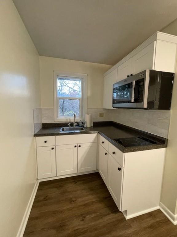 3503 State Route 208, Wilmington Twp, PA 16142 - kitchen with stainless steel microwave, dark wood-style floors, black electric cooktop, and dark countertops