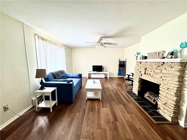 3503 State Route 208, Wilmington Twp, PA 16142 - living room with dark wood finished floors, a ceiling fan, and a stone fireplace