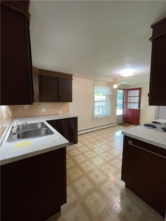 3503 State Route 208, Wilmington Twp, PA 16142 - kitchen with a baseboard heating unit, dark brown cabinetry, light flooring, and light countertops