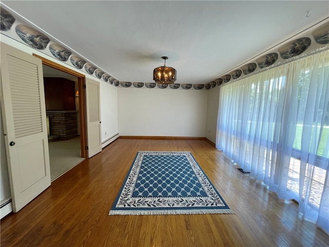 3503 State Route 208, Wilmington Twp, PA 16142 - spare room with baseboard heating, wood finished floors, and a chandelier