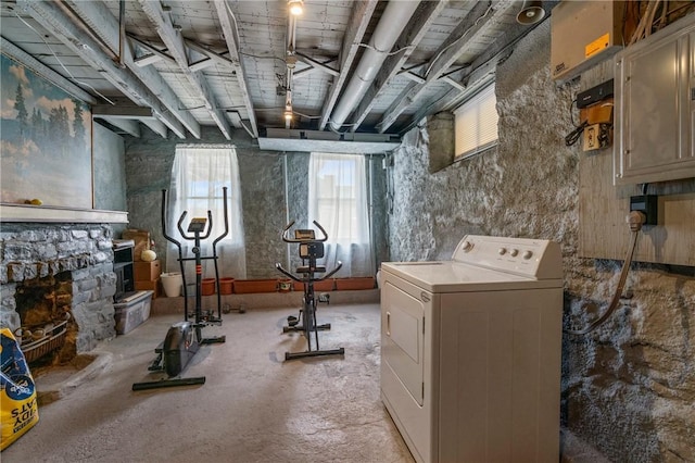 below grade area featuring washer / clothes dryer and a stone fireplace