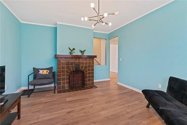 sitting room with crown molding, a fireplace, and wood finished floors