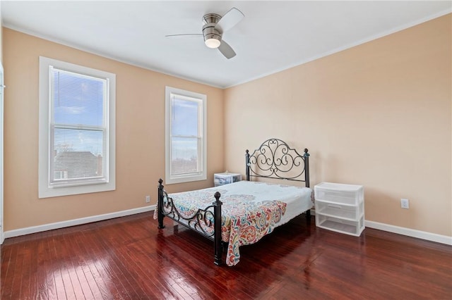 bedroom featuring ceiling fan, hardwood / wood-style floors, and baseboards