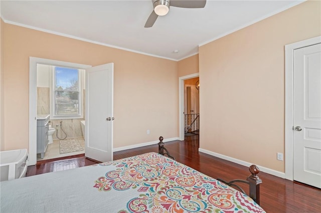 bedroom with ensuite bathroom, crown molding, baseboards, and wood finished floors