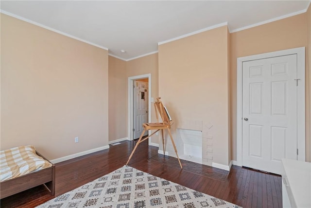 sitting room with baseboards, ornamental molding, and wood finished floors